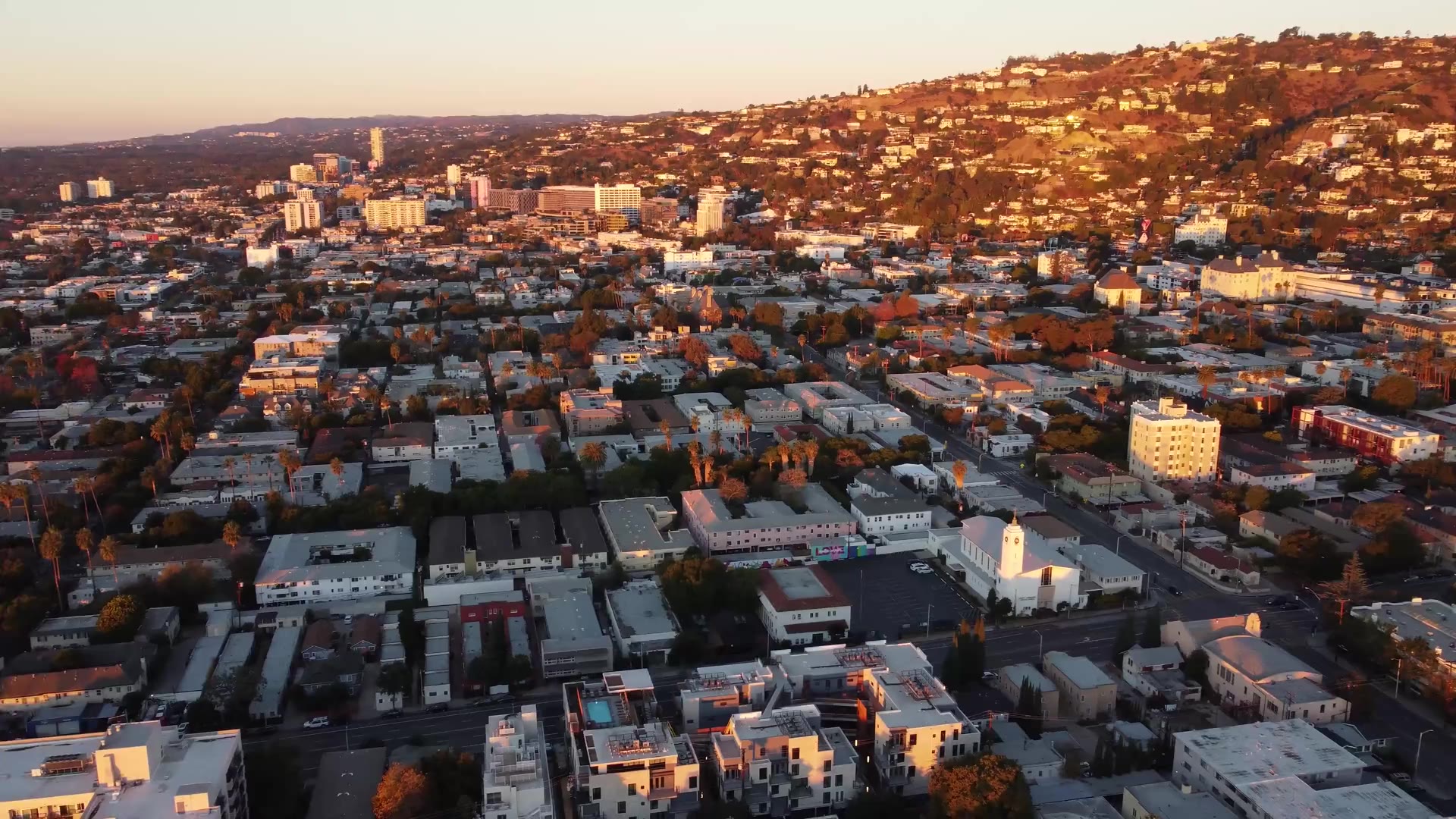 Aerial view of Los Angeles neighborhoods and the hills at golden hour